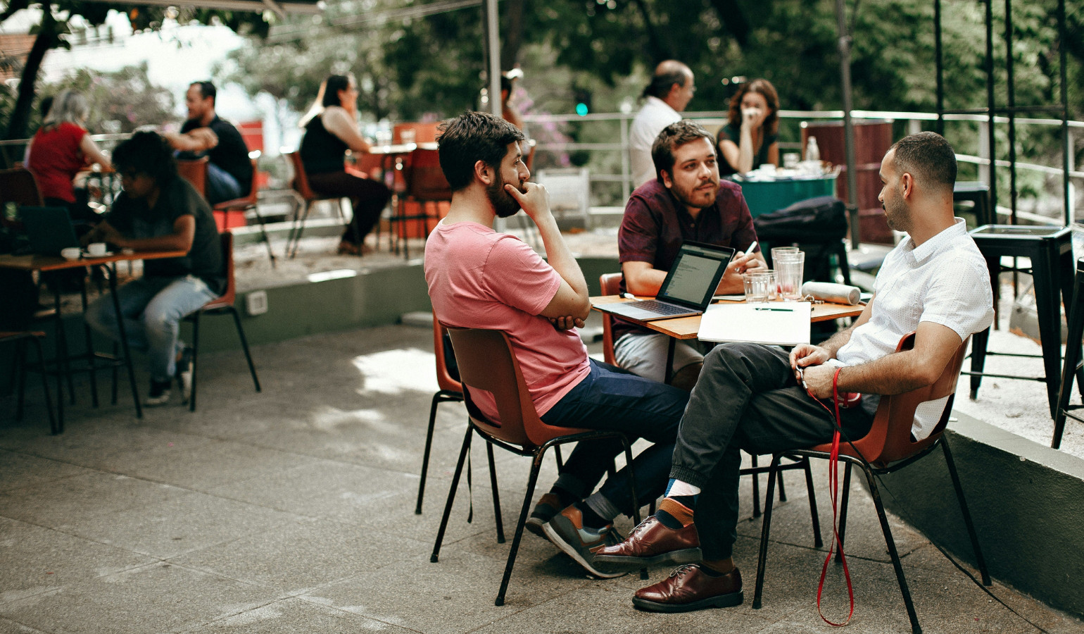 Men sitting at a table talking