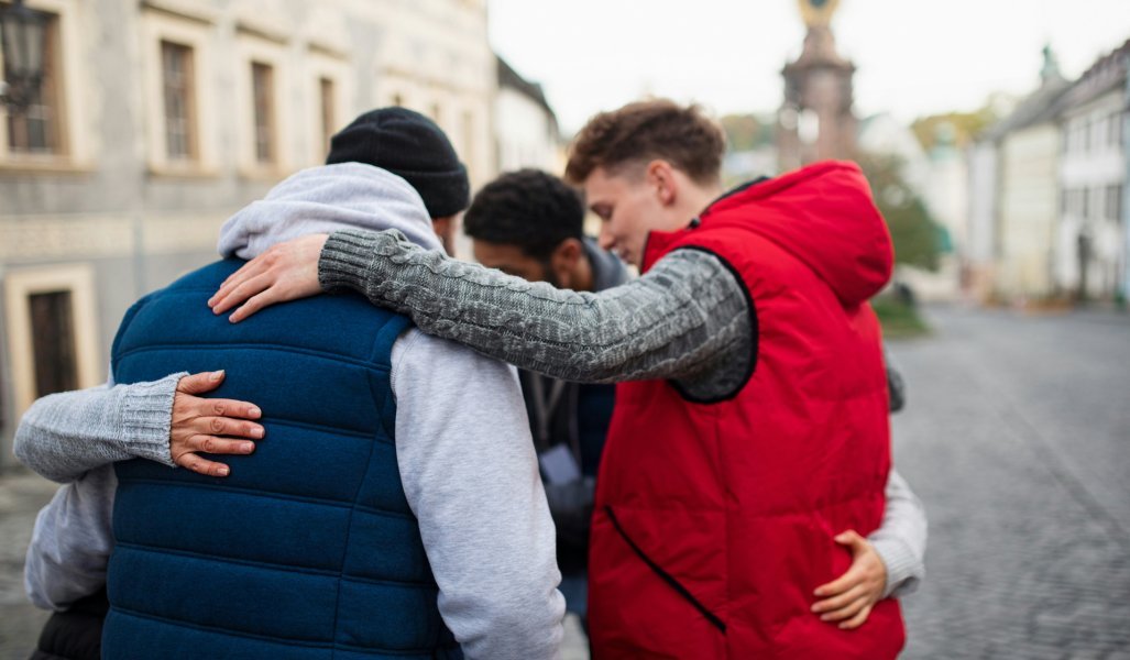 Group of mixed race friends praying together
