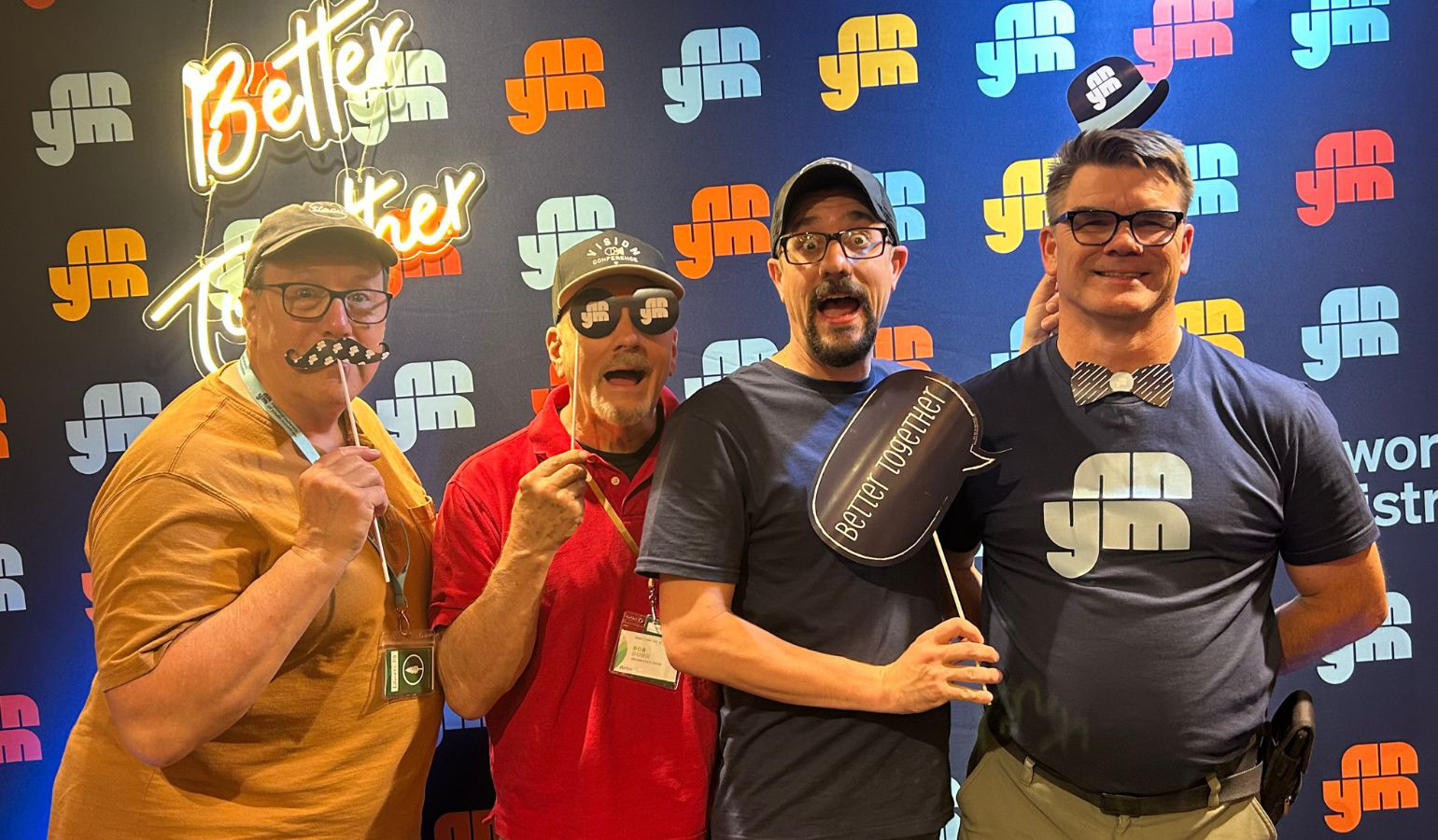 NNYM Team posing by Photobooth with props