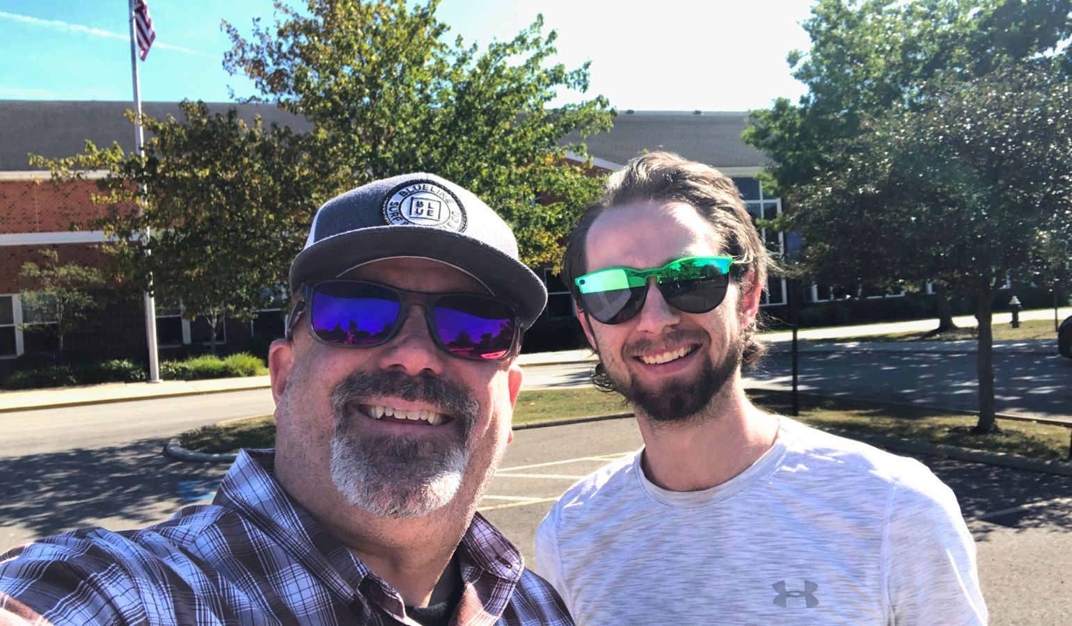 Two youth leaders in front of a school after praying over it