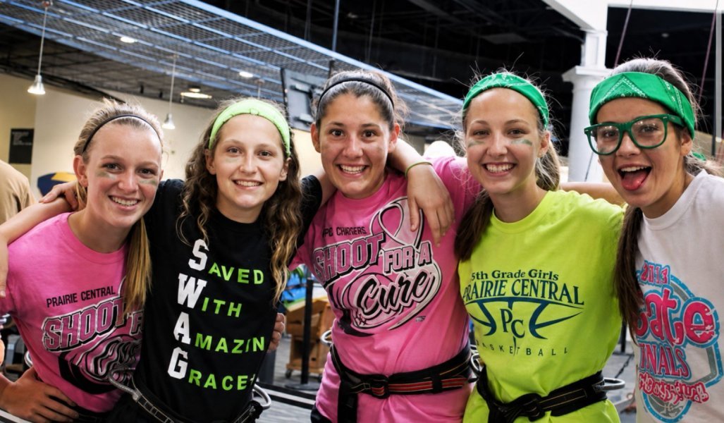 Group of friends linking arms and smiling