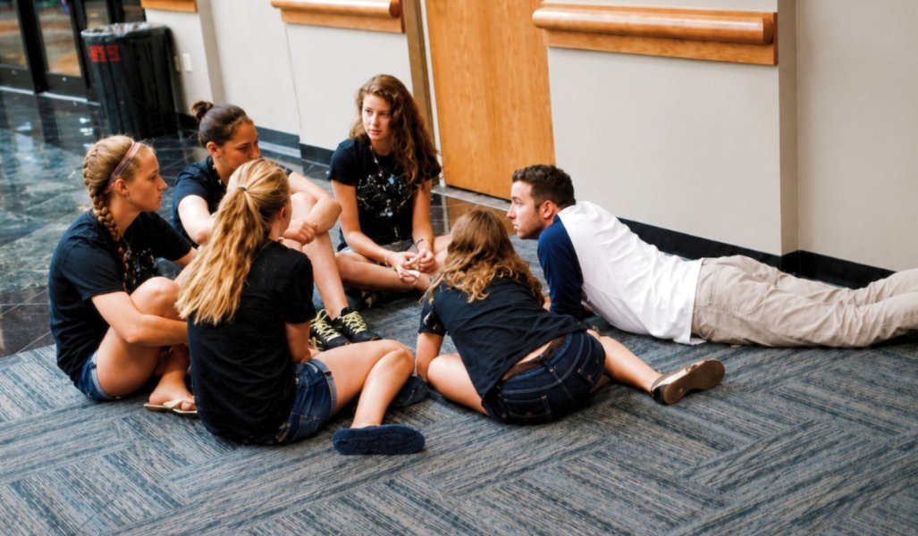 Students sitting on the floor having a salvation conversation