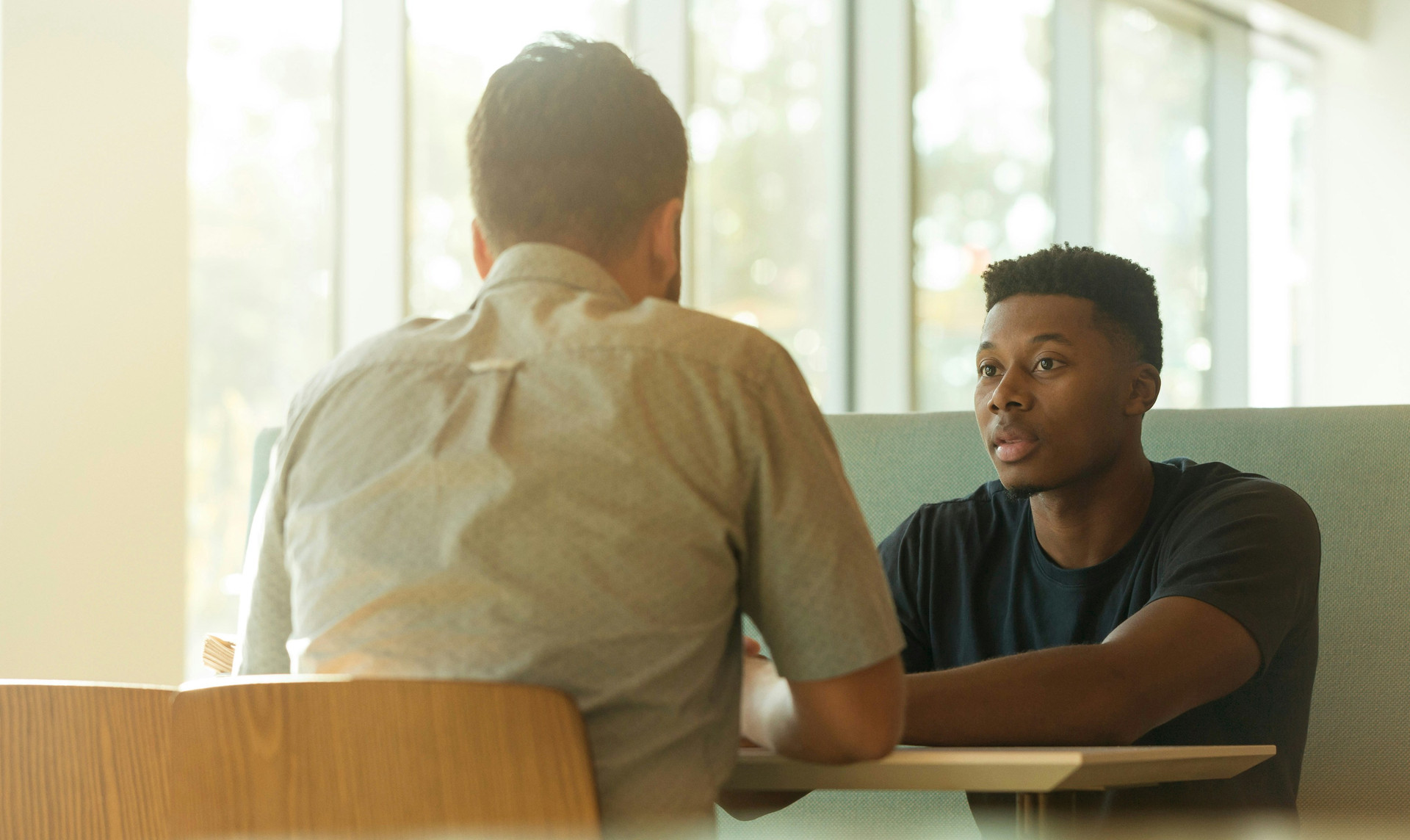 White man talking to african america youth