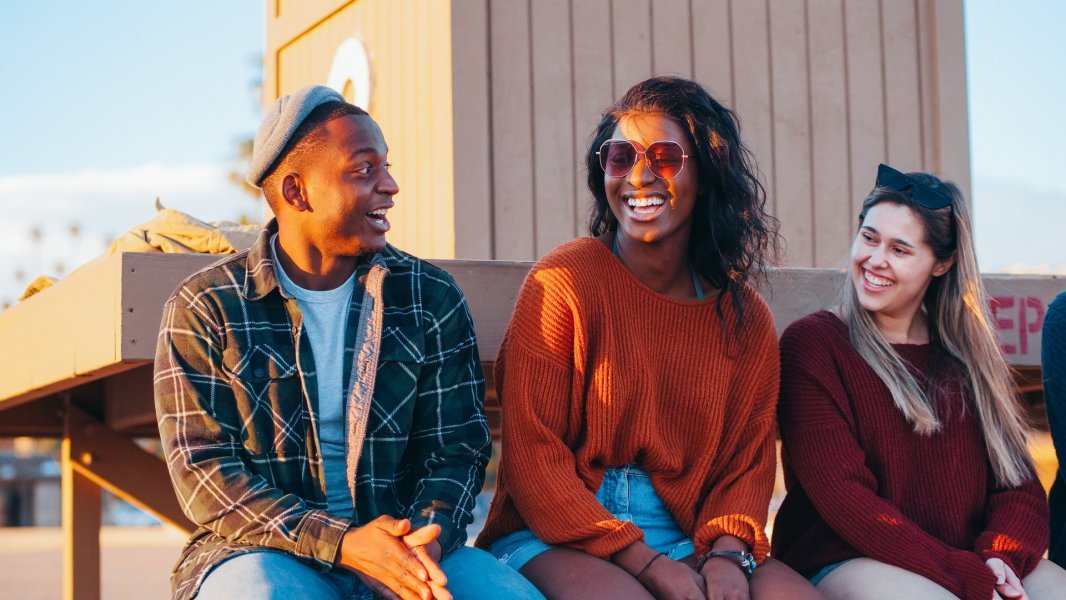 three young adults black and white