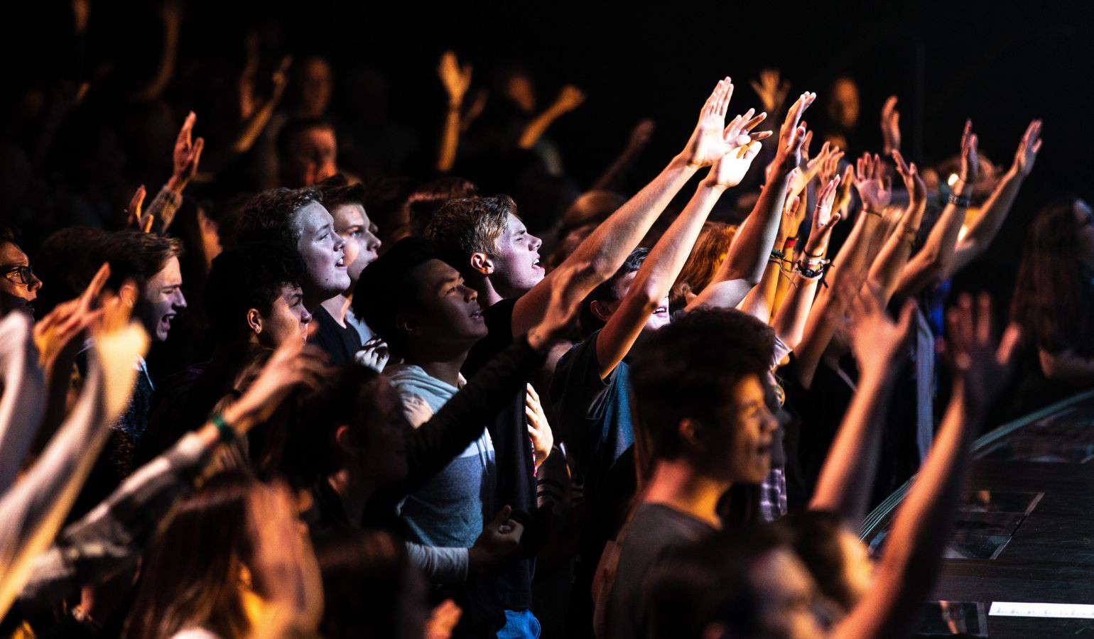 Teenagers worshipping and praying together