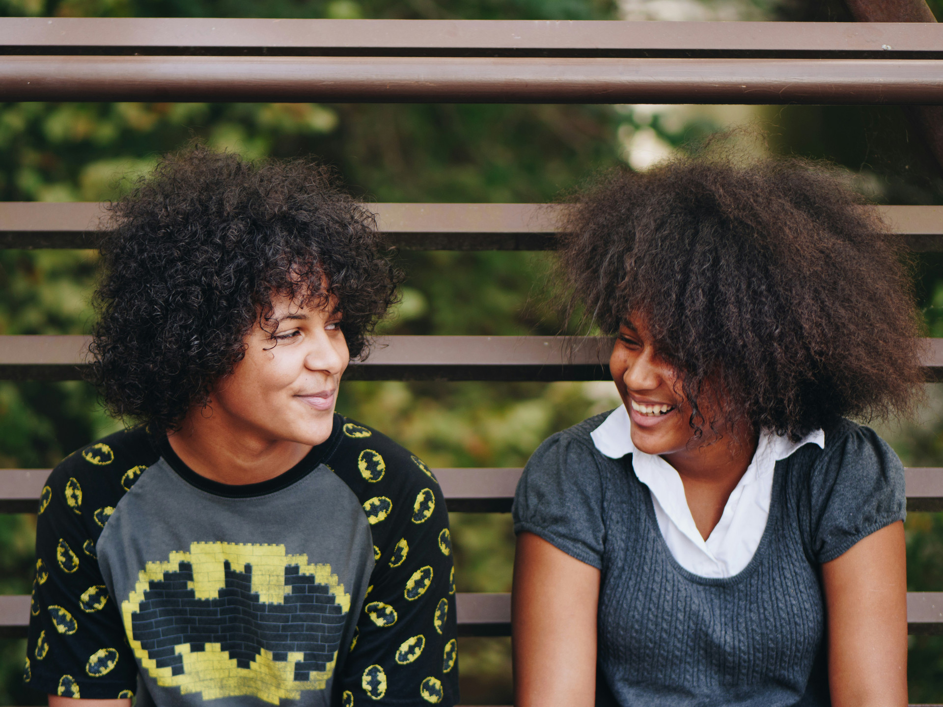 Two young African America youth smiling and chatting