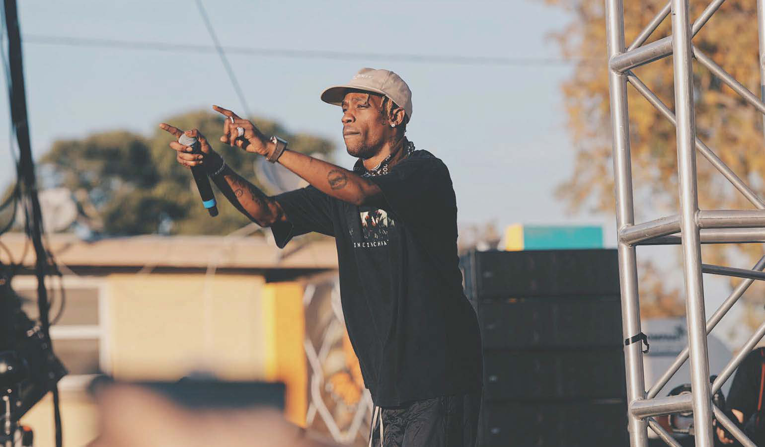 Black young male rapper on stage interacting with the crowd