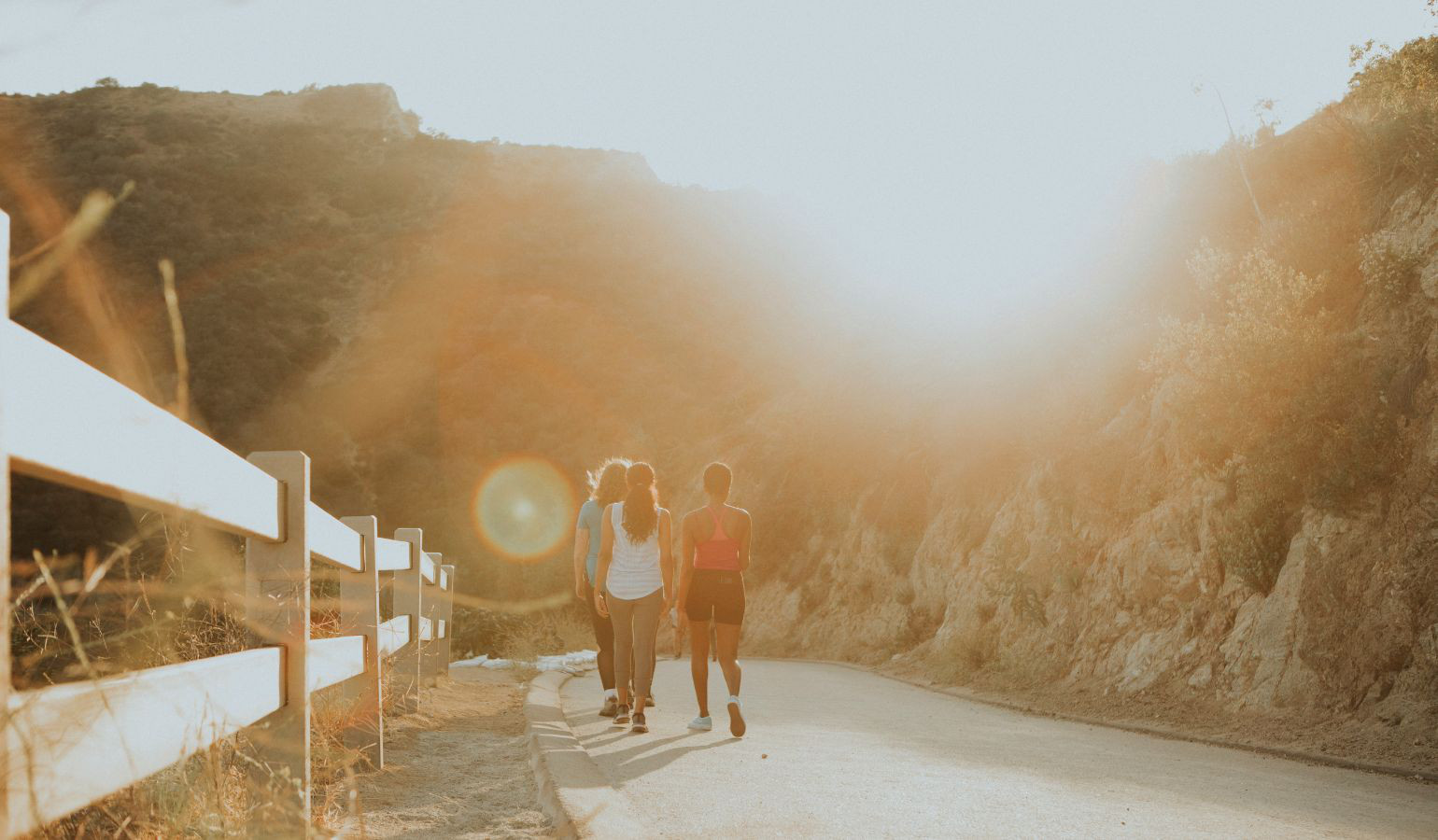 Women walking on path together at dusk