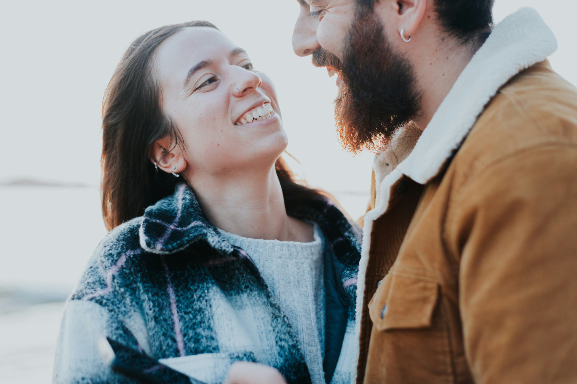 a couple standing in front of each other staring into each others eyes