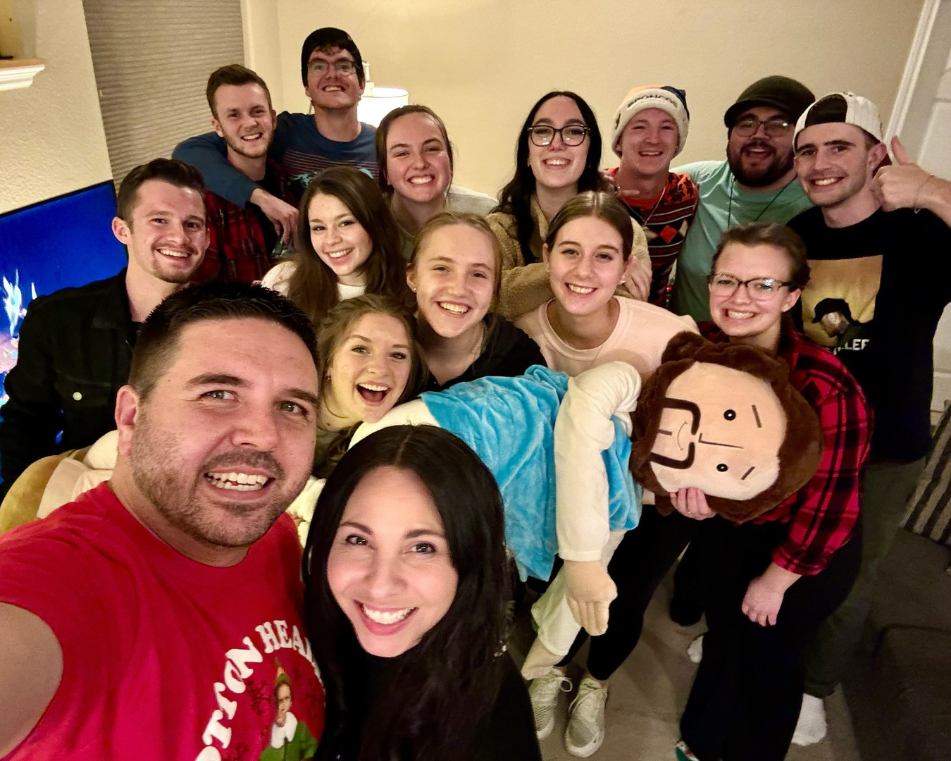 Yvette, Steve & youth snapping a fun selfie with a life-size plush Jesus