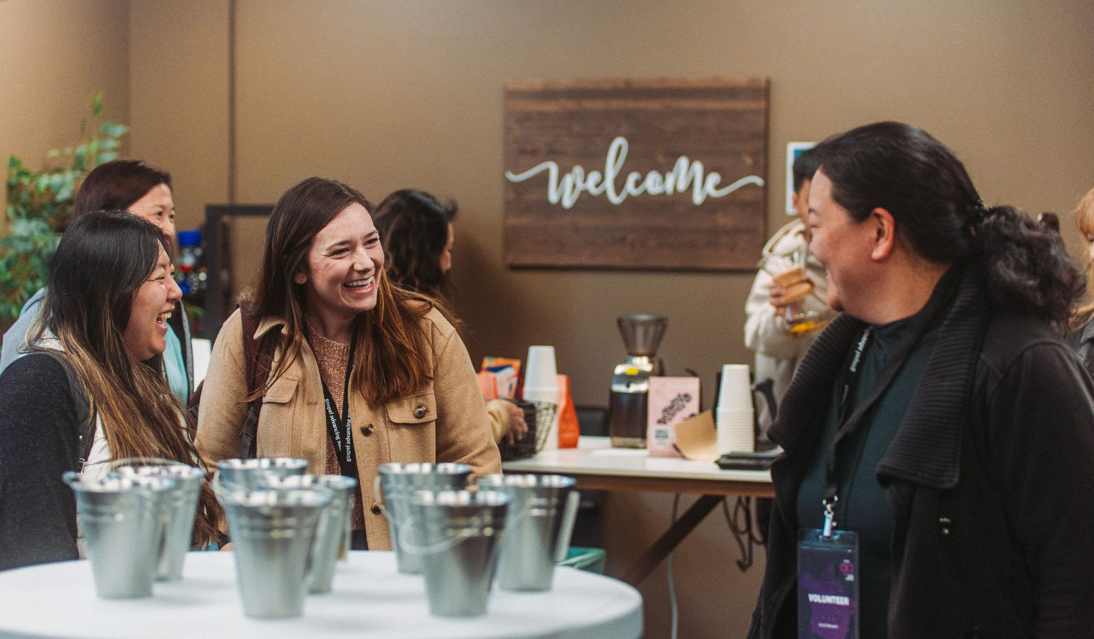 Women youth leaders talking and laughing around a table