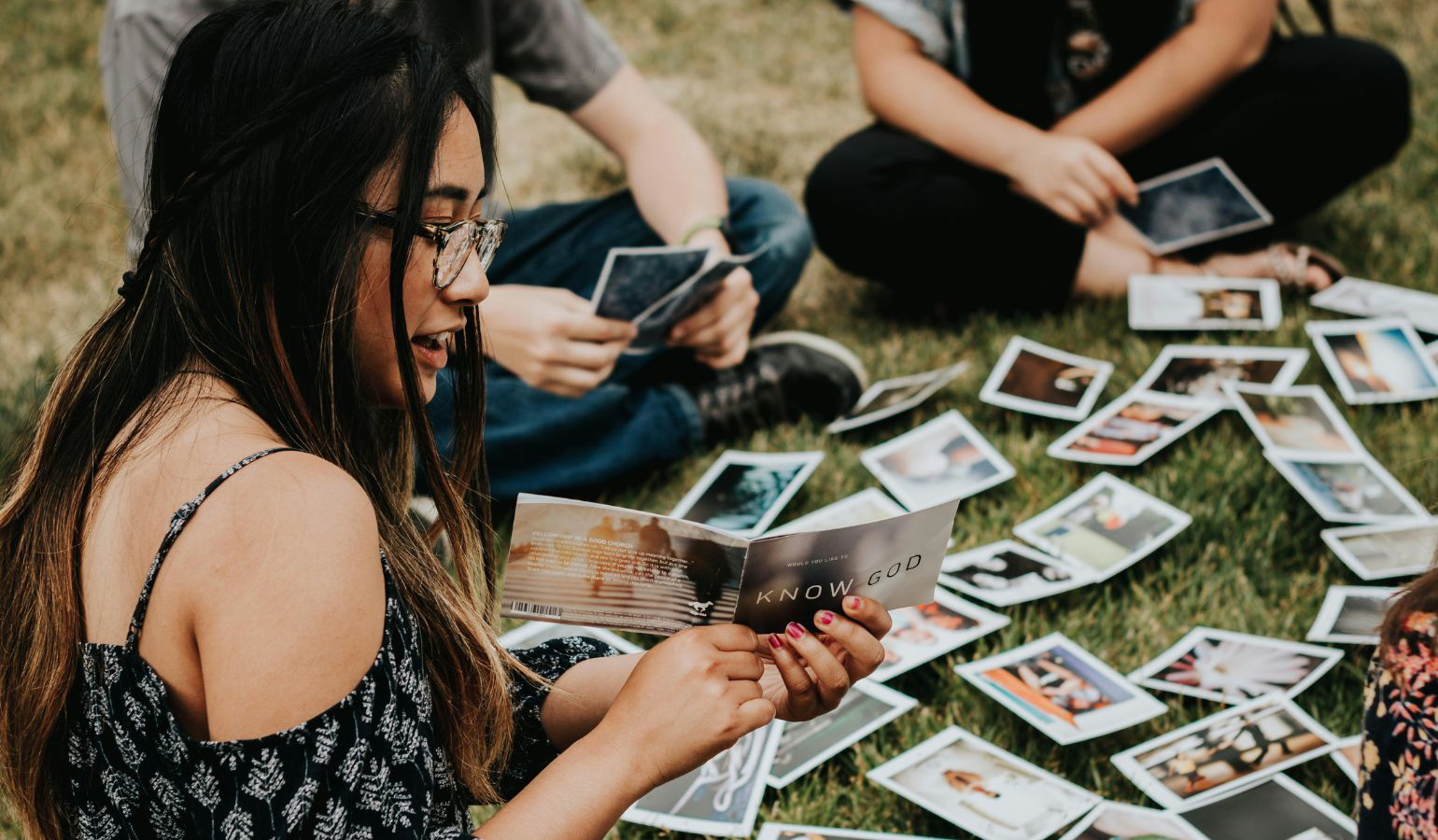 Asian young adult sharing gospel tract with others