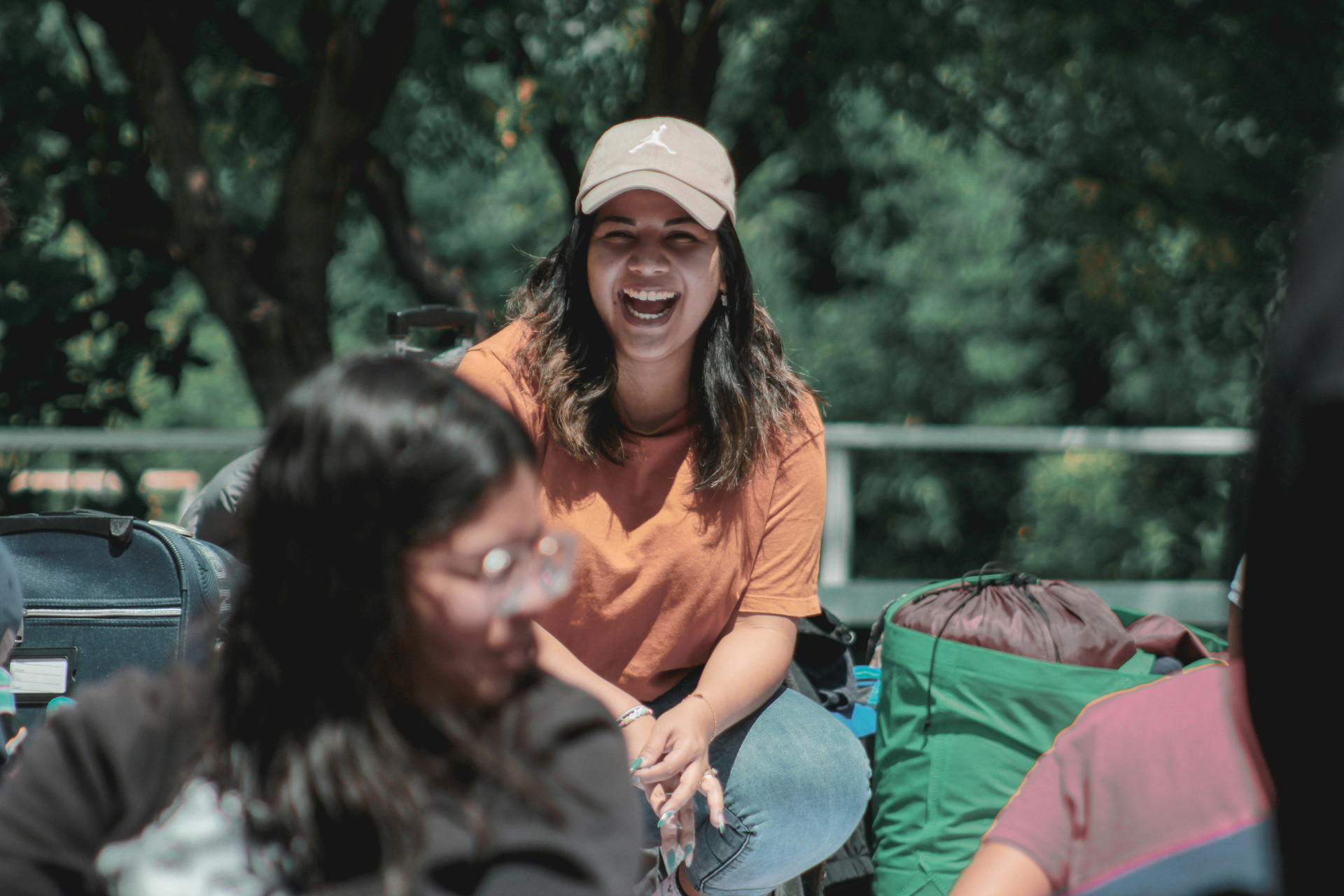 Young woman smiling and sitting at a camp