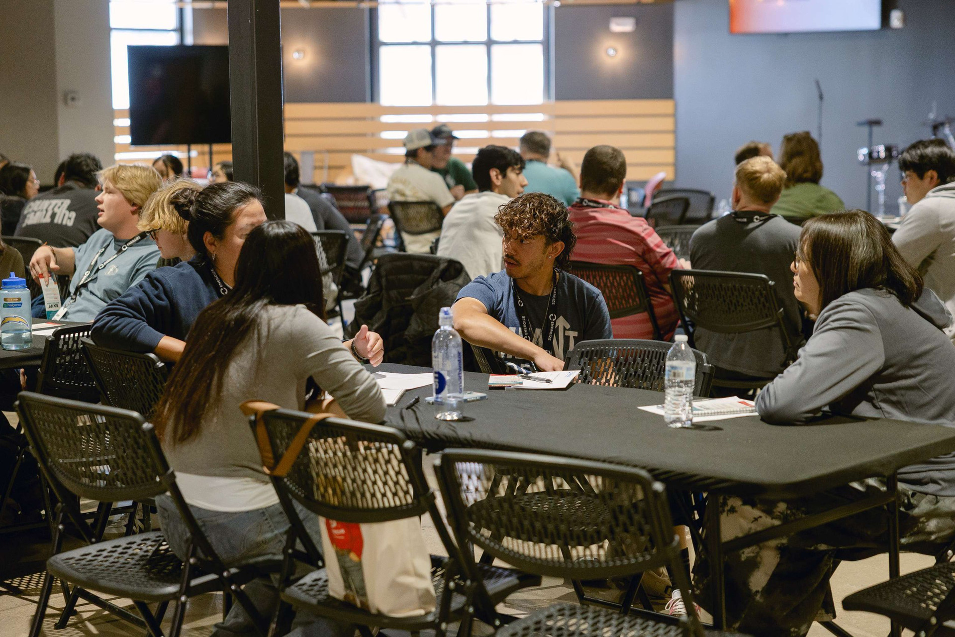 Youth leaders gathering around tables talking