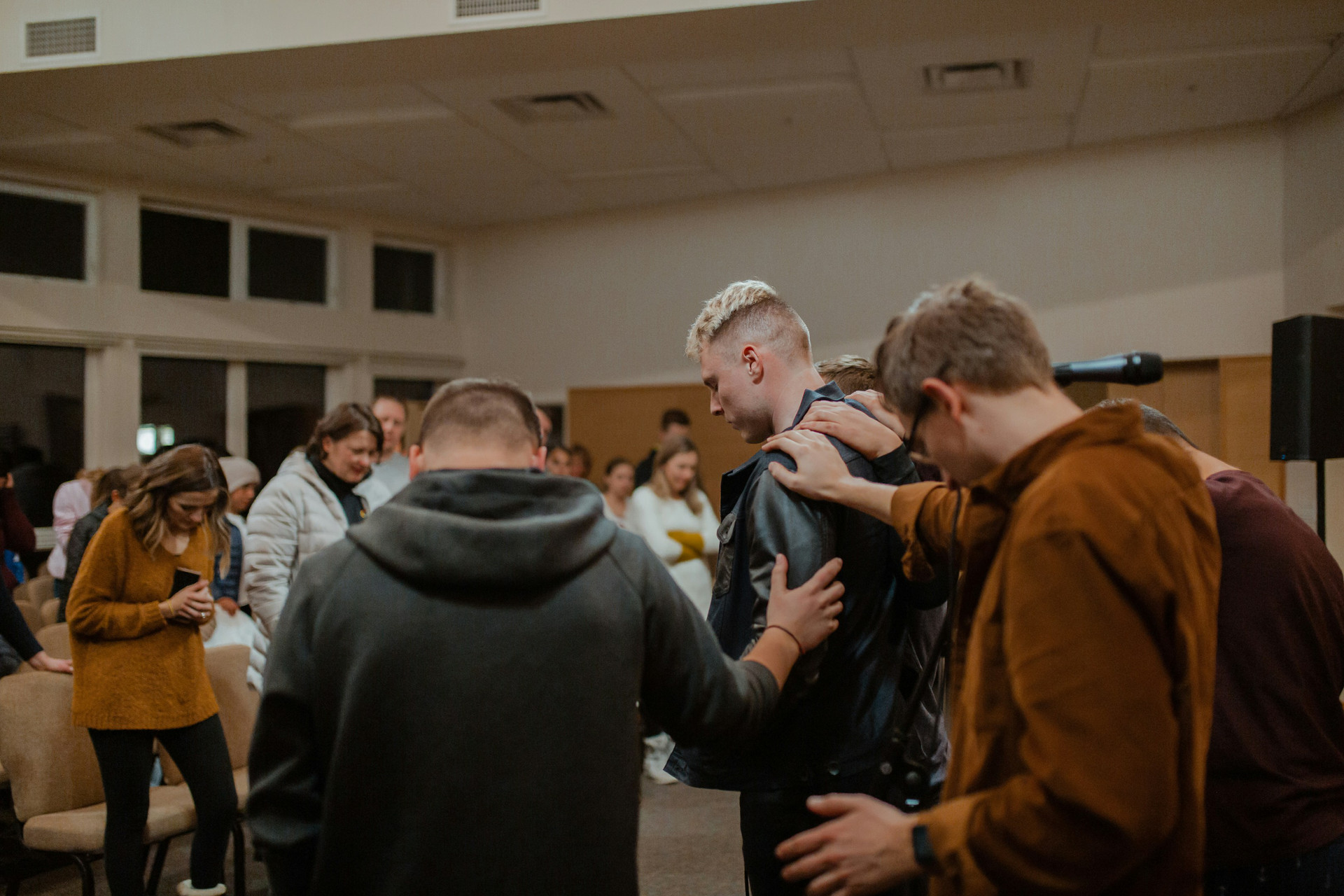 Youth praying over a student at youth group