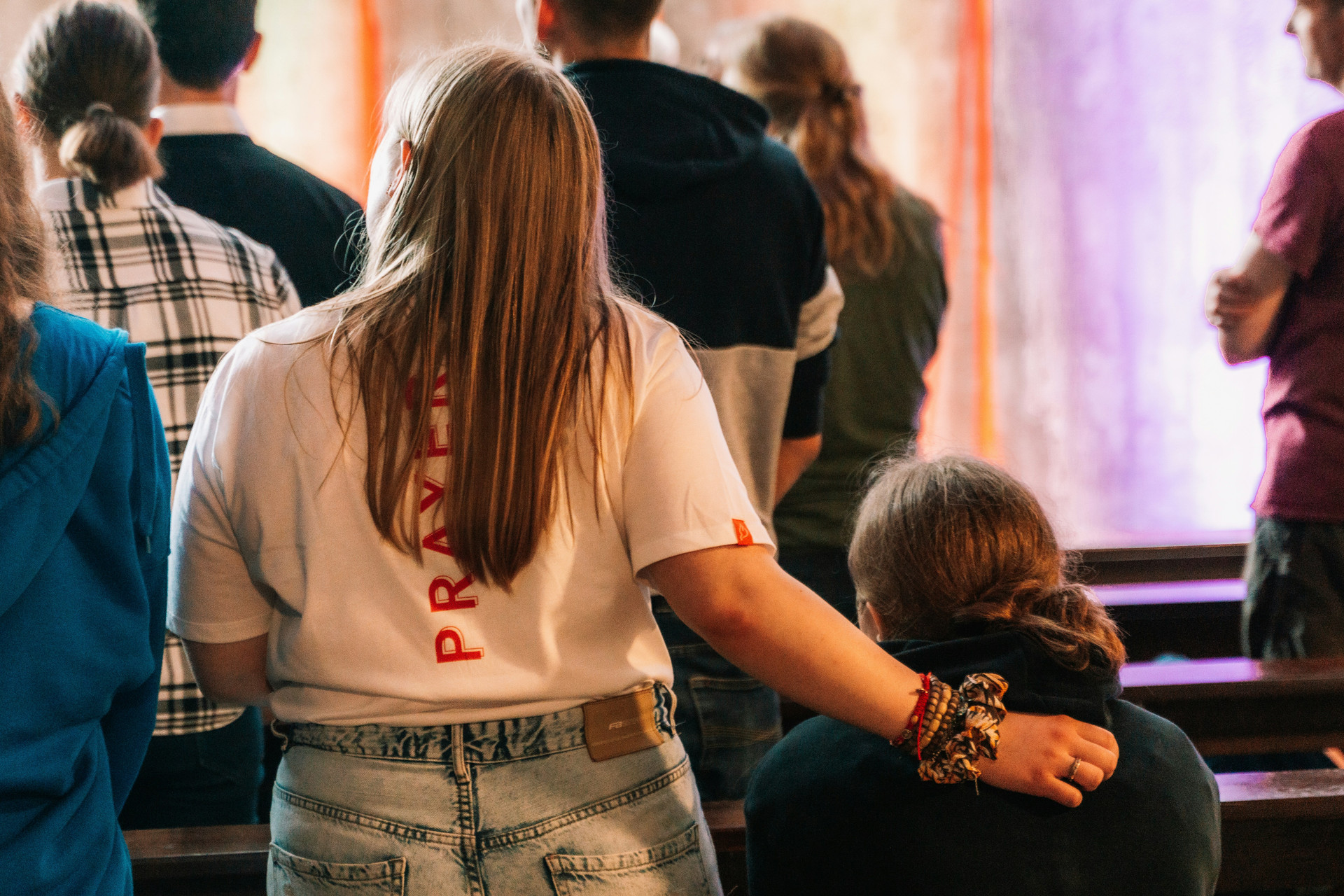 Students in a conference space praying and listening.