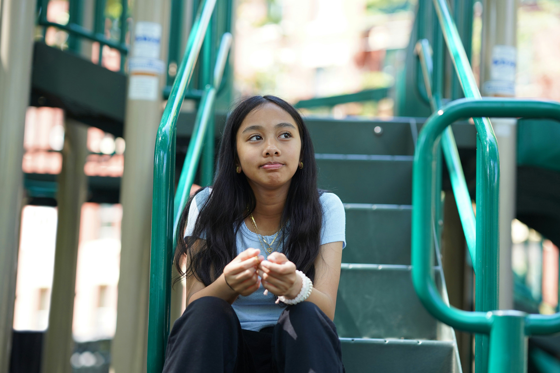 Student sitting at some playground steps alone