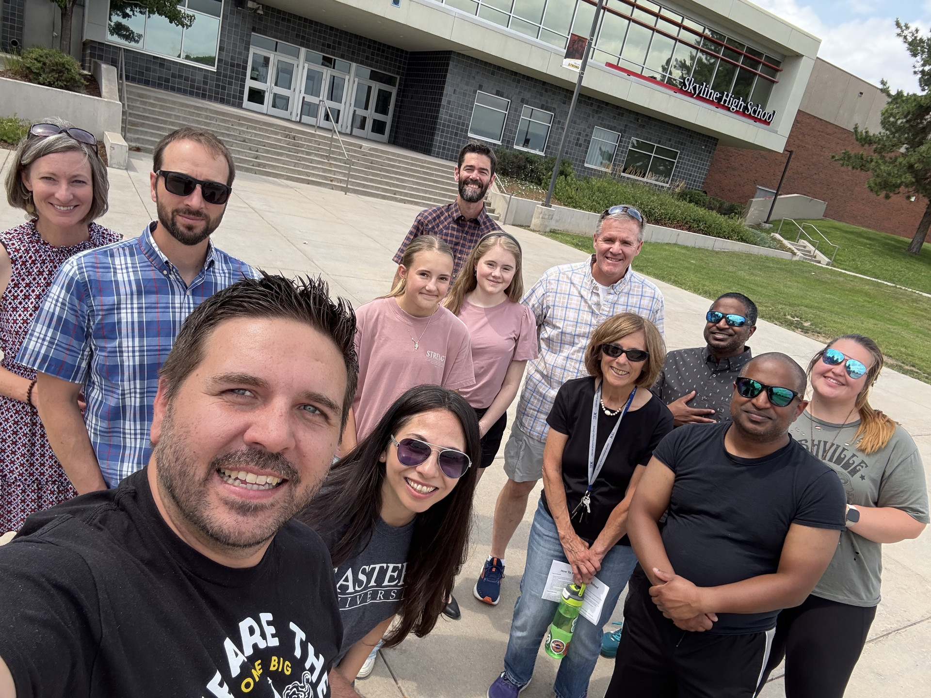 Youth leaders and students outside a school after praying at footprints on campus.