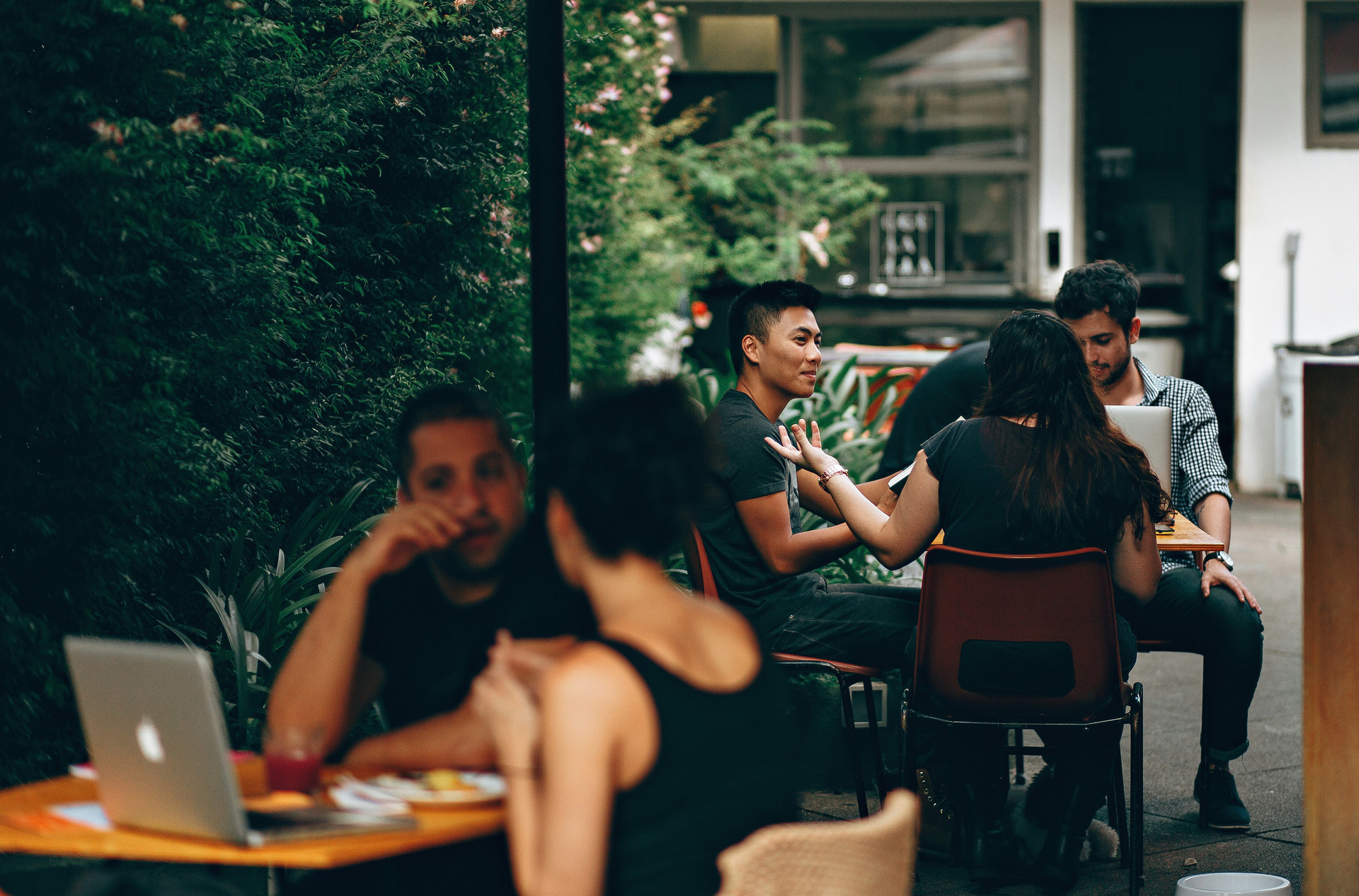 group of young adults meeting in a patio restaurant