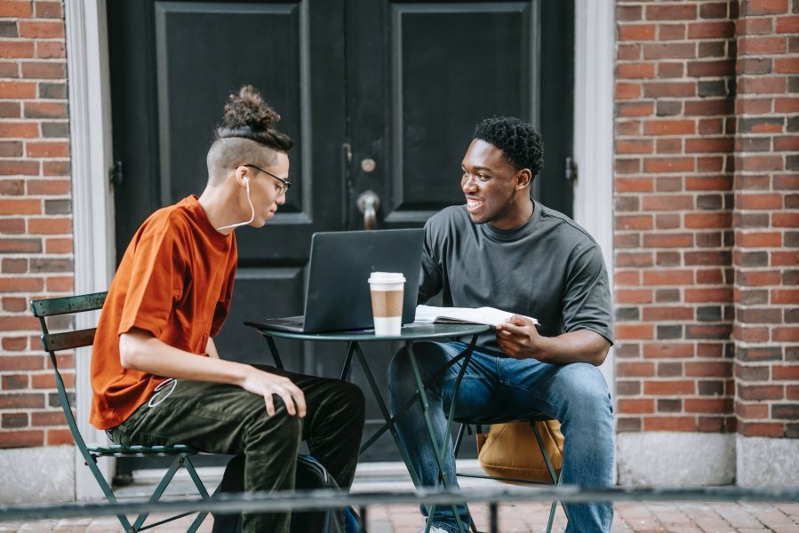Young white male and black male working together