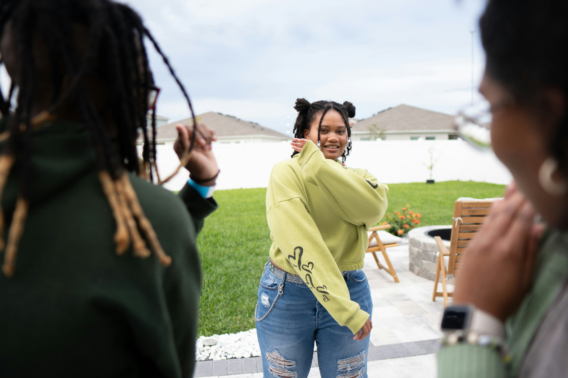 Three black young women looking at each other and dabbing.