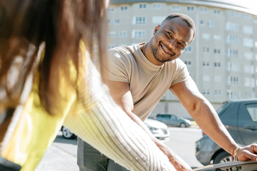 Young man looking up and smiling at a young woman.