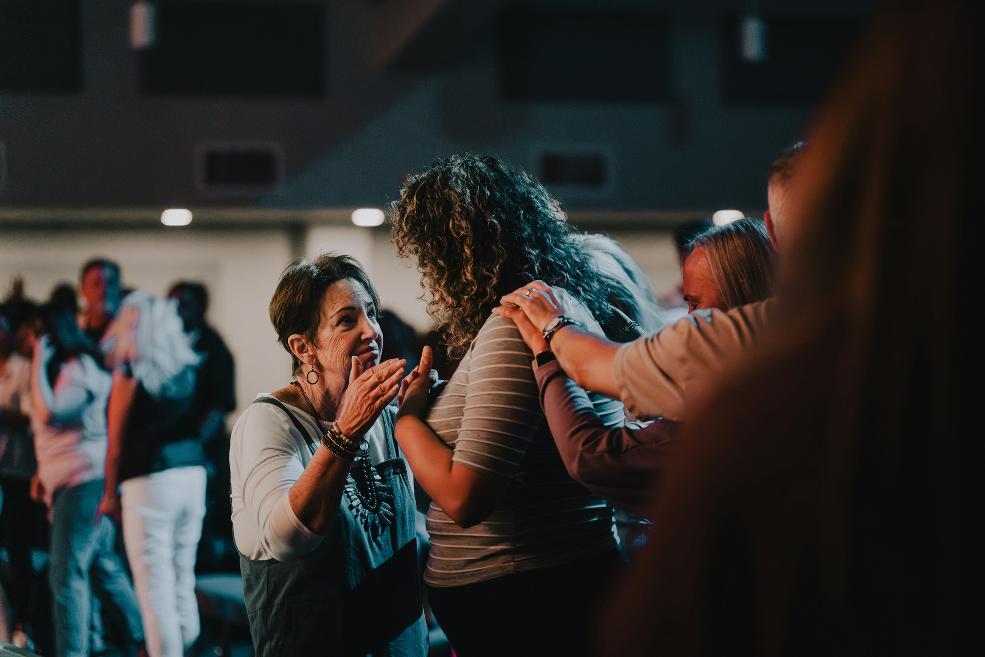 Youth leaders praying over each other.
