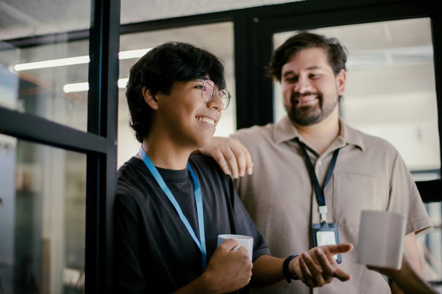 Young volunteers chatting in office hallway
