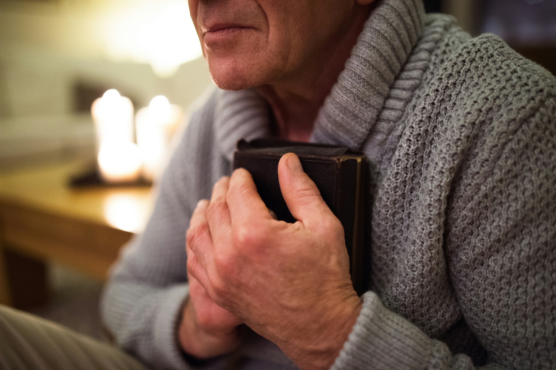 Man clutching his Bible by his heart