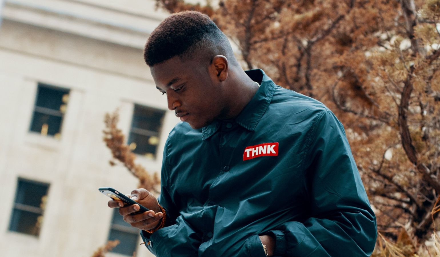 African American teen looking at phone